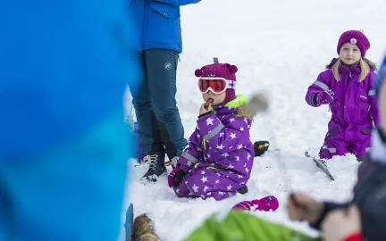 Barn leker i sn&oslash;en og spiser p&oslash;le
